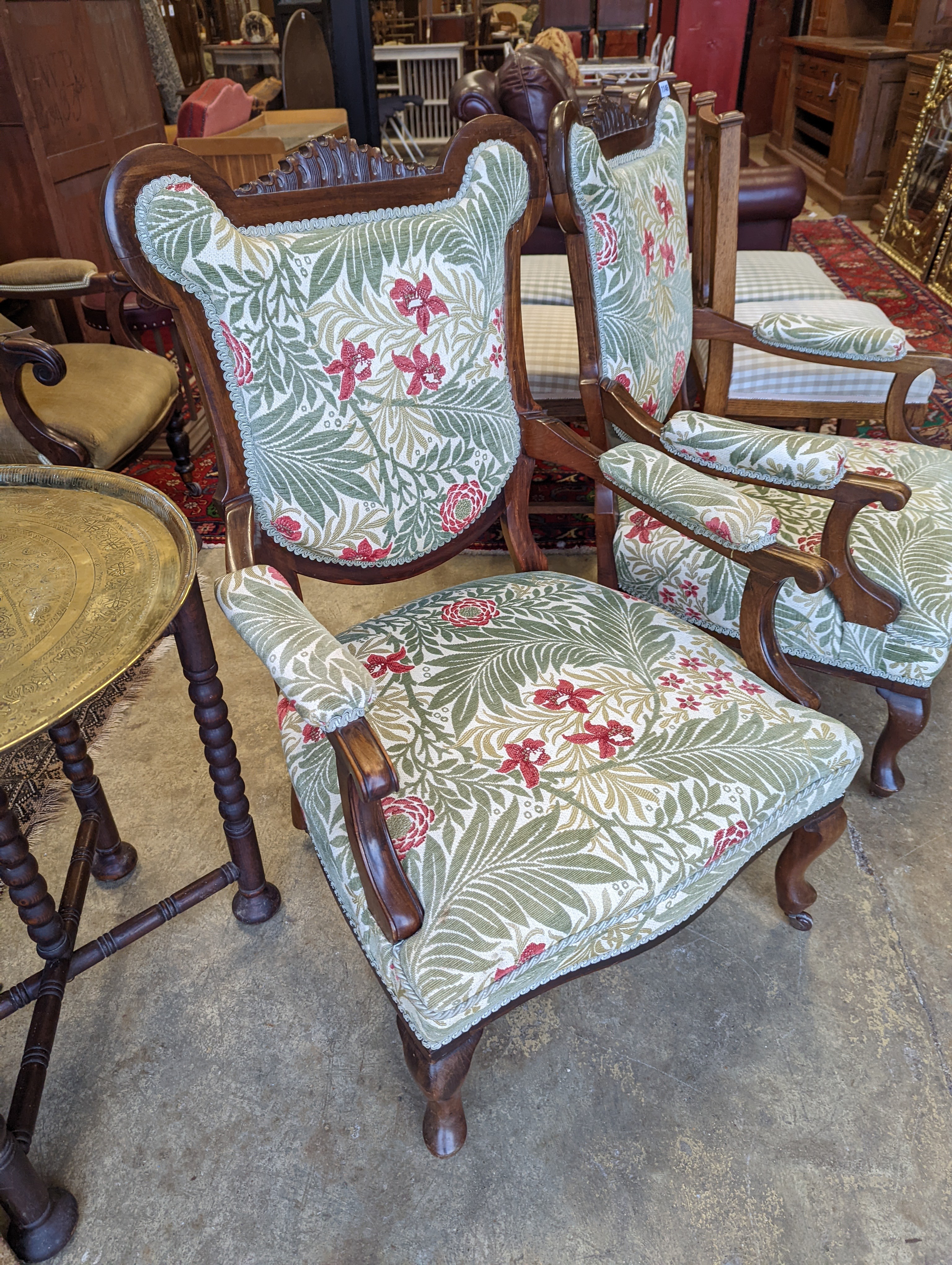 A pair of late Victorian mahogany upholstered drawing room chairs